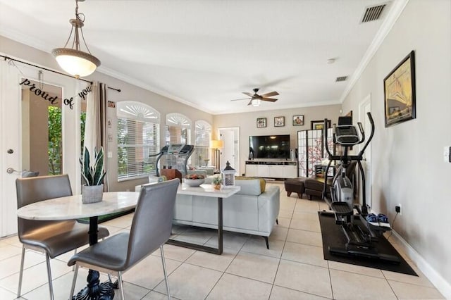 tiled living room with ornamental molding and ceiling fan