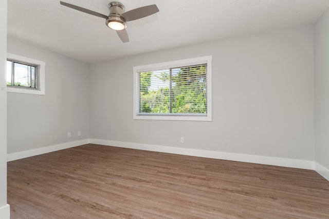 unfurnished room with hardwood / wood-style floors and ceiling fan