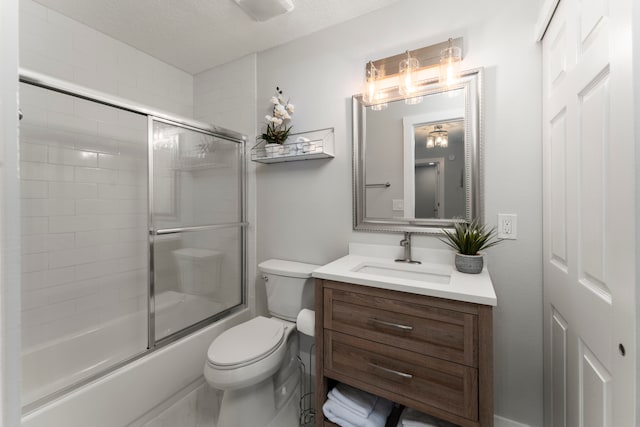 full bathroom with vanity, toilet, shower / bath combination with glass door, and a textured ceiling