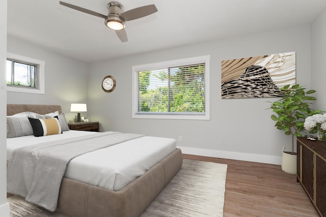 bedroom with wood-type flooring and ceiling fan