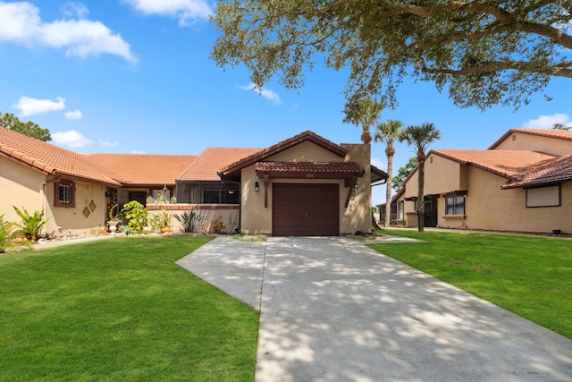 mediterranean / spanish home featuring a garage and a front yard