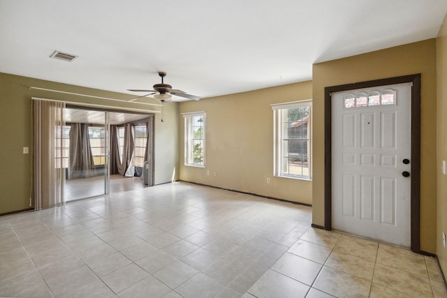 tiled entryway with ceiling fan