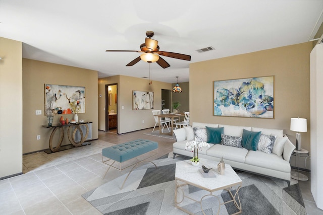 tiled living room with ceiling fan