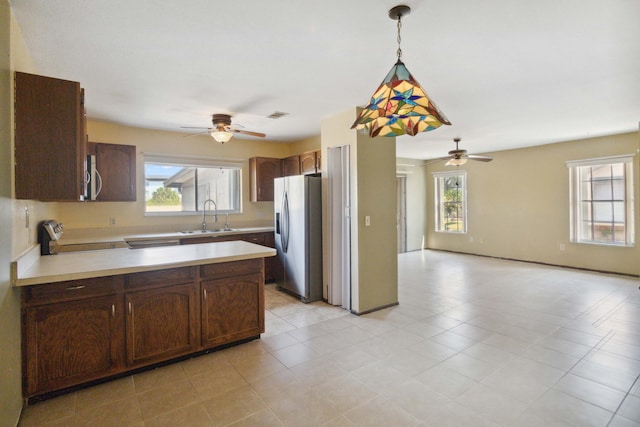 kitchen featuring sink, a healthy amount of sunlight, pendant lighting, and appliances with stainless steel finishes