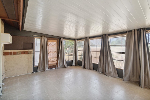 unfurnished sunroom featuring vaulted ceiling