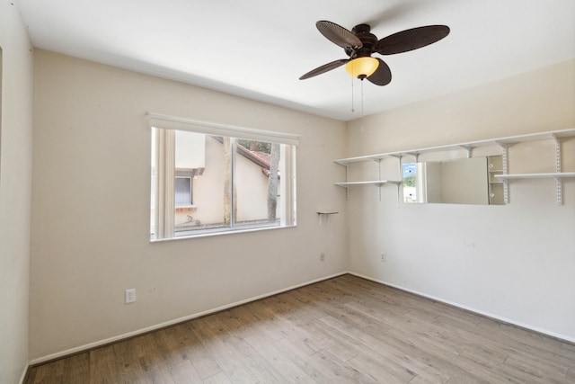 unfurnished room featuring ceiling fan and hardwood / wood-style floors