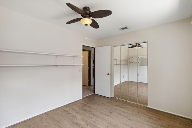 unfurnished bedroom with a closet, ceiling fan, and hardwood / wood-style floors