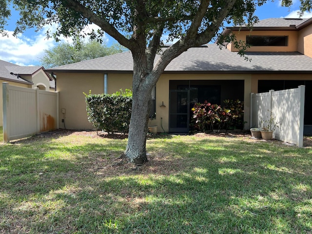 rear view of property with a yard