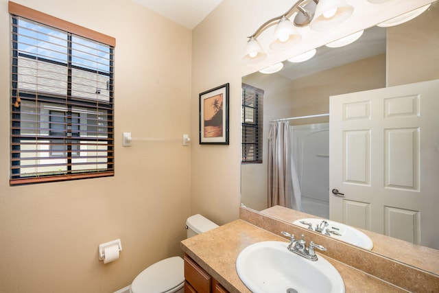 bathroom featuring toilet and large vanity