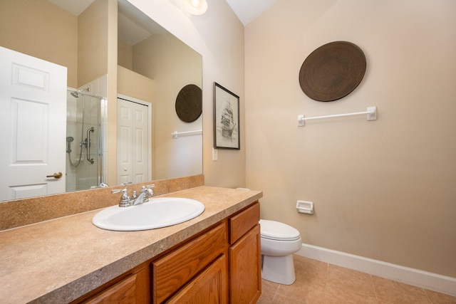 bathroom with vanity, toilet, tile floors, and a shower with shower door