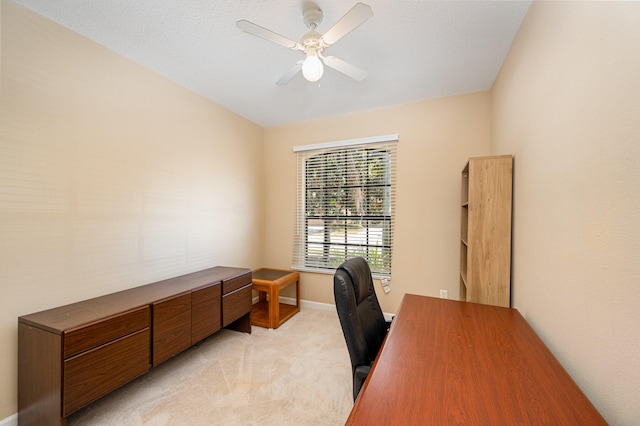 carpeted home office with ceiling fan