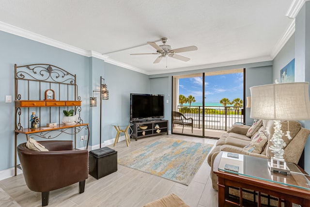 living room with ornamental molding, ceiling fan, and expansive windows