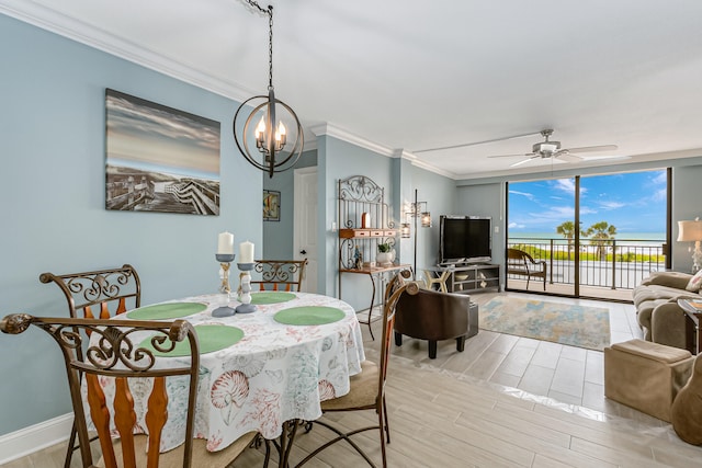 dining room with light hardwood / wood-style floors, ceiling fan with notable chandelier, and crown molding