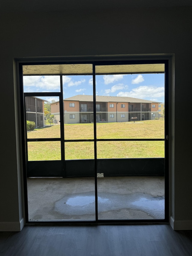 doorway featuring a healthy amount of sunlight and dark wood-type flooring