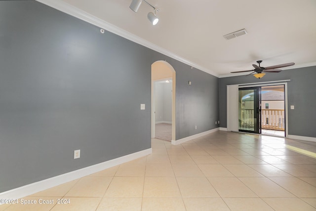 tiled spare room featuring ornamental molding and ceiling fan