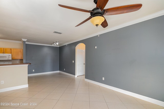 unfurnished living room featuring light tile patterned flooring, ornamental molding, and ceiling fan