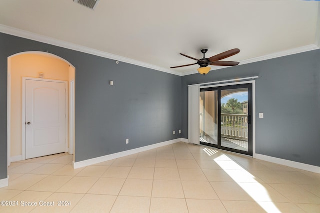 unfurnished room with ceiling fan, crown molding, and light tile patterned floors