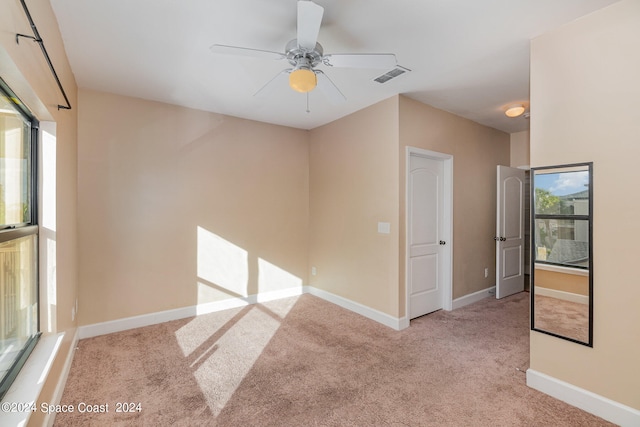 carpeted empty room with ceiling fan