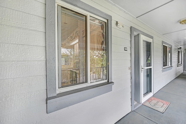 view of exterior entry featuring a porch