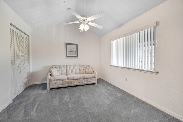 unfurnished room featuring vaulted ceiling, ceiling fan, and dark colored carpet