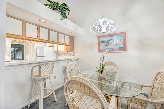 carpeted dining room featuring an inviting chandelier