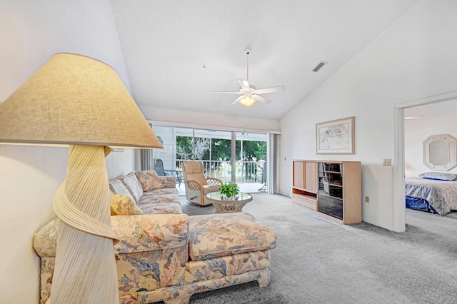 living room with high vaulted ceiling, ceiling fan, and carpet