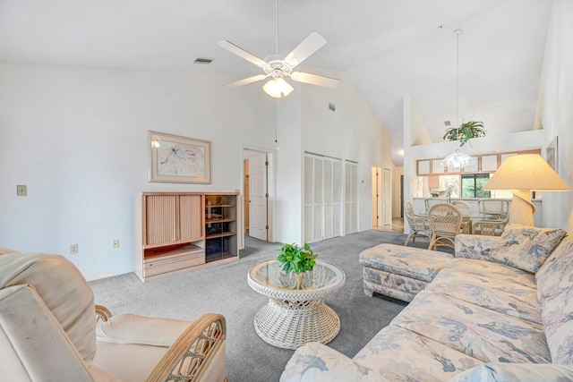 carpeted living room with high vaulted ceiling and ceiling fan