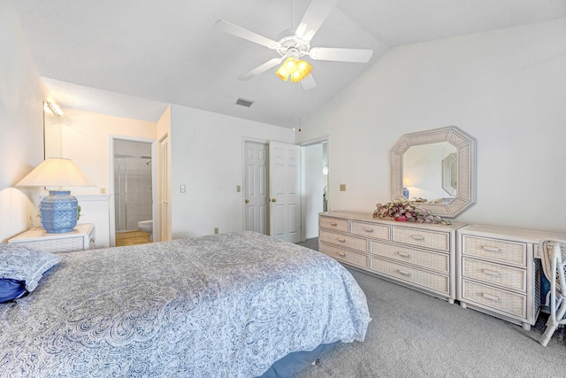 carpeted bedroom with ensuite bath, ceiling fan, and vaulted ceiling