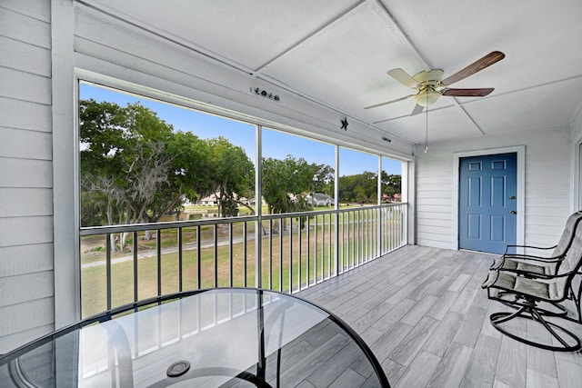 sunroom / solarium featuring plenty of natural light and ceiling fan