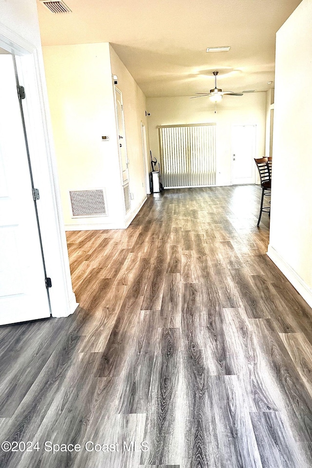 unfurnished room with dark hardwood / wood-style floors and ceiling fan