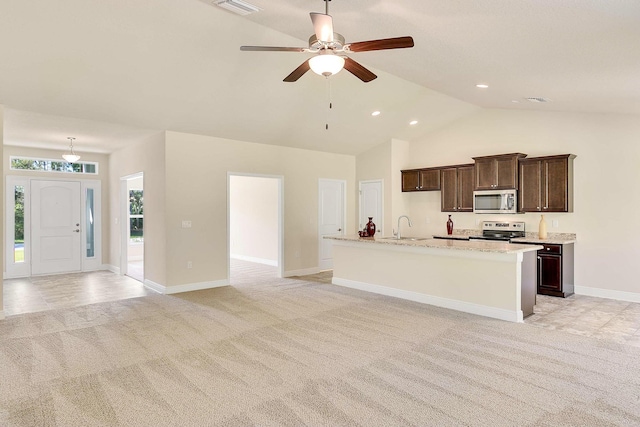 kitchen with light carpet, ceiling fan, stainless steel appliances, and sink