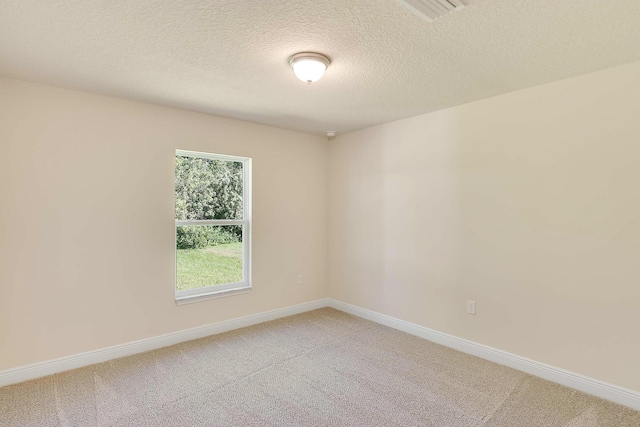 unfurnished room with a textured ceiling and carpet