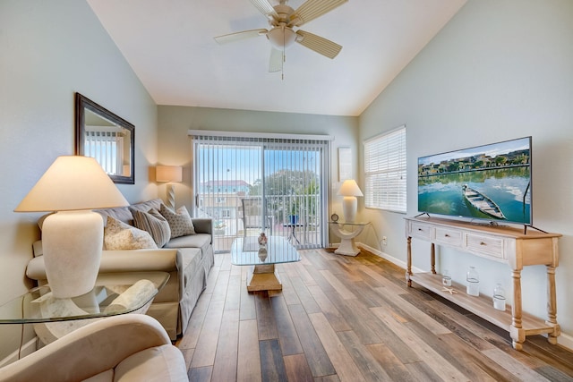 living room featuring high vaulted ceiling, ceiling fan, and light hardwood / wood-style floors