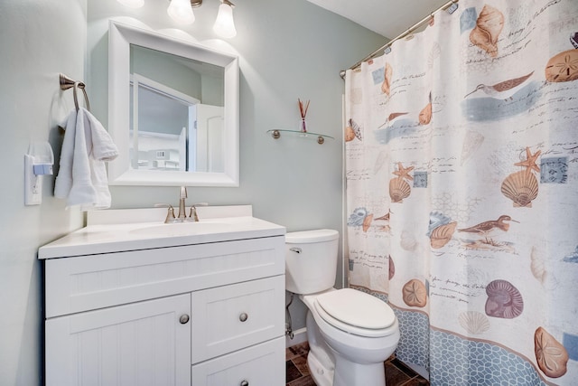 bathroom featuring vanity, toilet, and tile patterned flooring