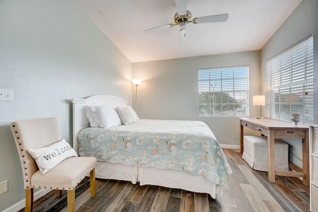 bedroom with wood-type flooring, ceiling fan, and lofted ceiling