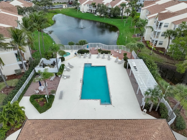 view of swimming pool with a patio and a water view