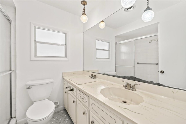 bathroom featuring tile flooring, oversized vanity, toilet, and a wealth of natural light