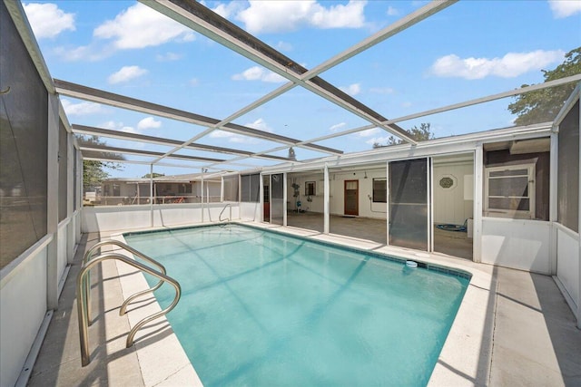 view of pool featuring glass enclosure and a patio area