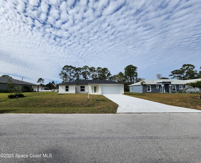 ranch-style home with a garage and a front yard