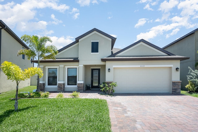 view of front of property with a front lawn and a garage