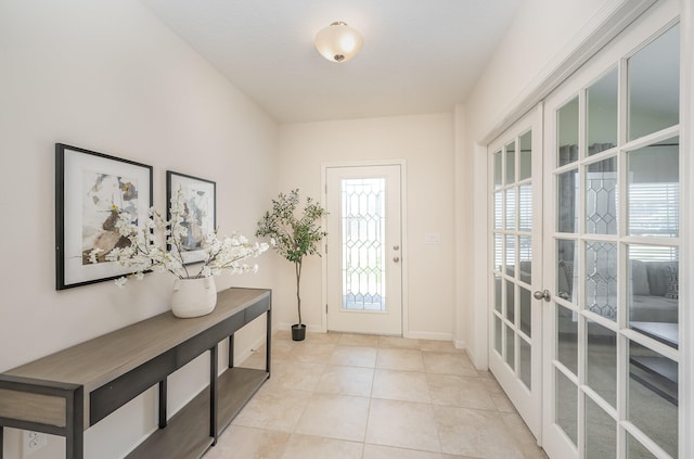 doorway to outside with light tile patterned flooring