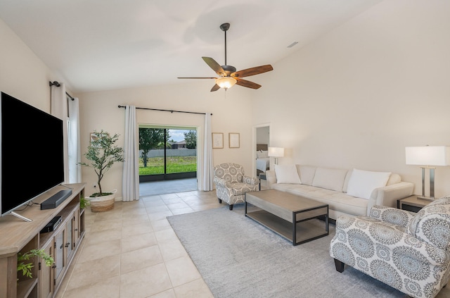 tiled living room with ceiling fan and high vaulted ceiling