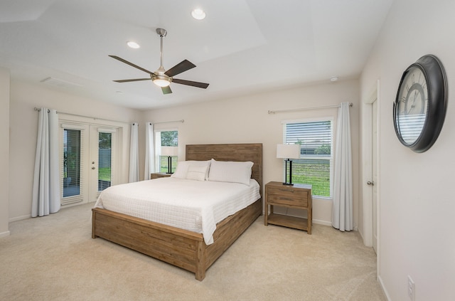 carpeted bedroom featuring ceiling fan, french doors, access to outside, and multiple windows