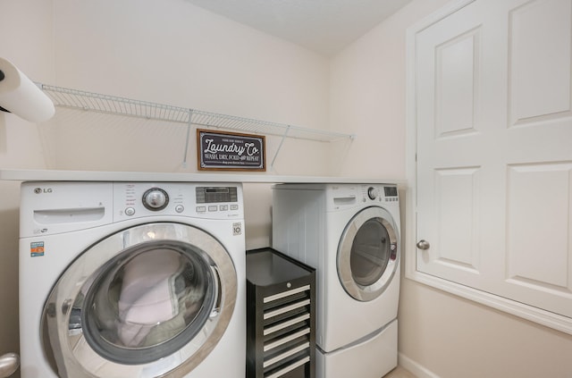 washroom with washer and dryer