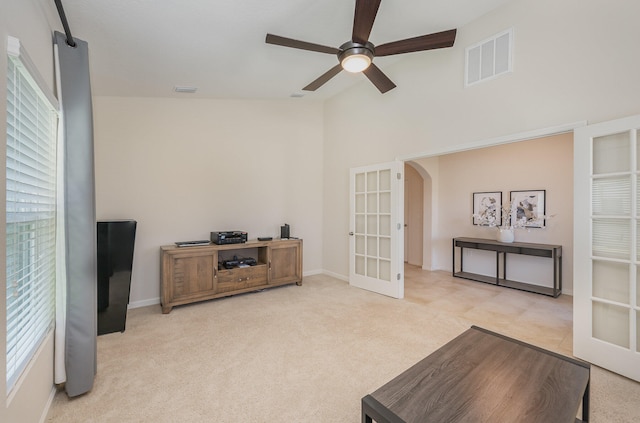 interior space with french doors, light colored carpet, ceiling fan, and lofted ceiling