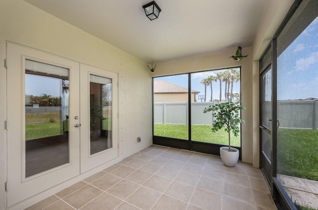 unfurnished sunroom featuring french doors