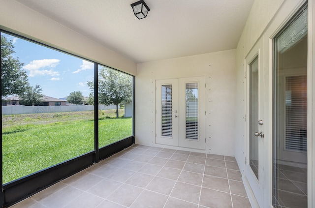 unfurnished sunroom with french doors