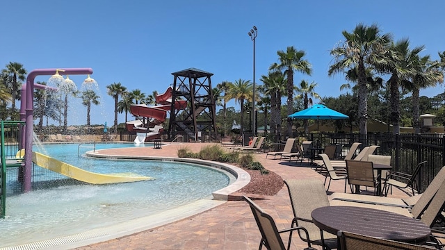 view of pool featuring pool water feature and a patio