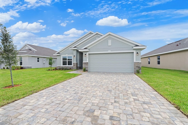 view of front of property featuring a garage and a front lawn