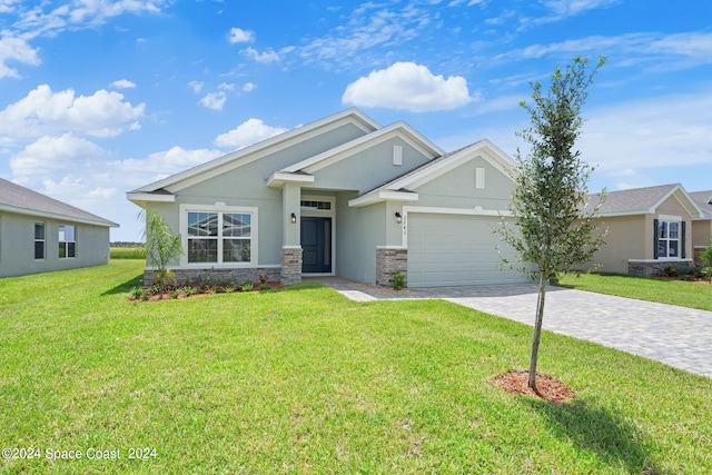 view of front of home with a garage and a front lawn